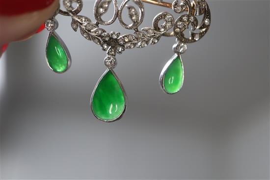 A 1920s yellow metal, diamond and jadeite set drop openwork scroll brooch, width 38mm.